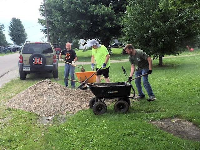 3 men working with shovels and wheelbarrows