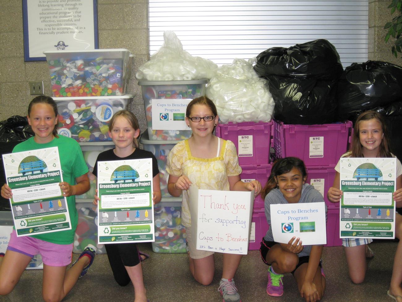 5 children holing up the DCRW Recycling signs