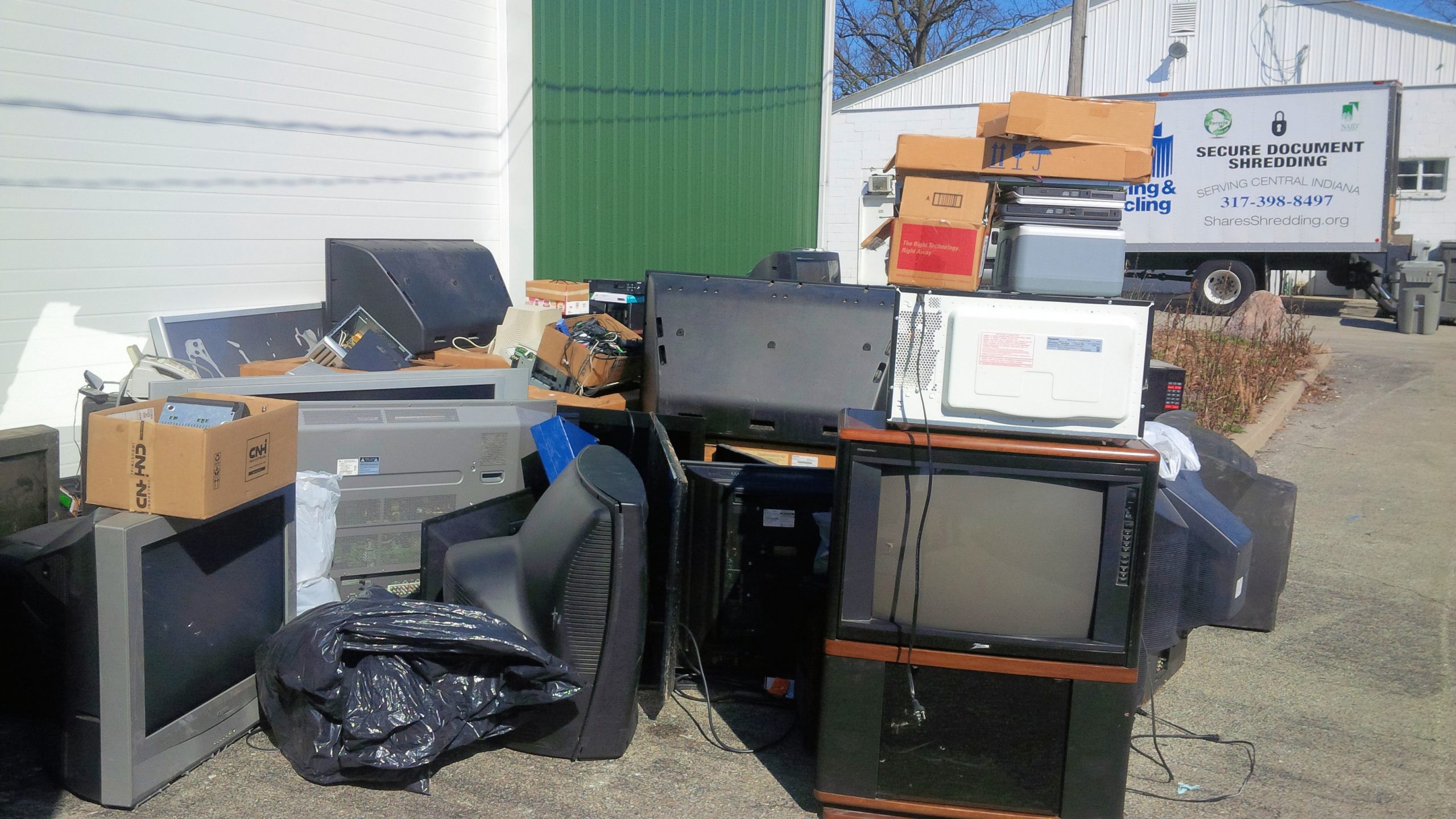Old TVs and microwaves piled up